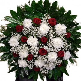 Funeral wreath with red roses and white chrysanthemums