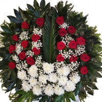 Elegant funeral wreath with red roses and white chrysanthemums